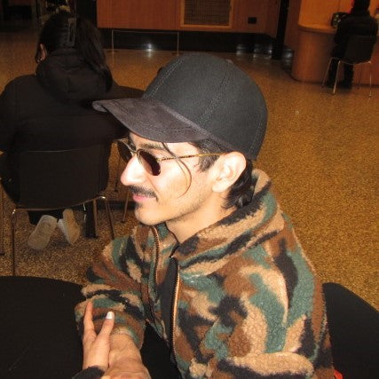 Sideview of man wearing wool black Derby Bowler hat with suede brim.