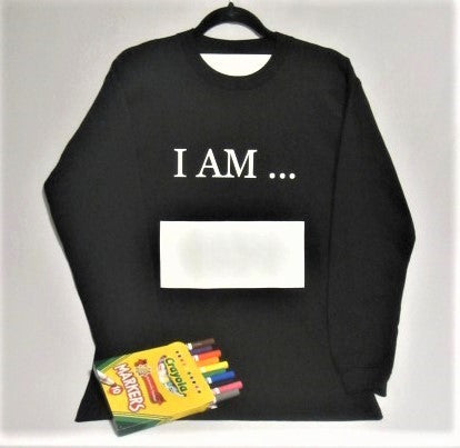 Long sleeve black Affirm tee shirt, with printed words I AM and large white writing block, with washable markers