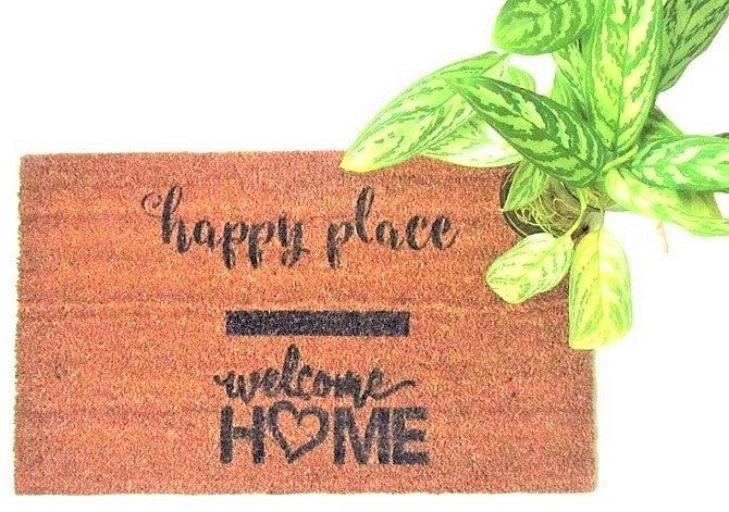 Natural fiber  welcome home doormat with black hand painted words Happy Place Welcome Home, house plant for decor.